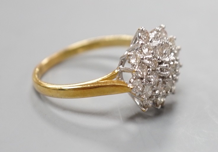 A modern 18ct gold and diamond cluster set flower head ring, size R/S, gross weight 5.5. grams.